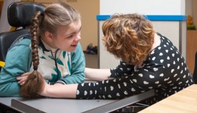 young girl with disability and support worker